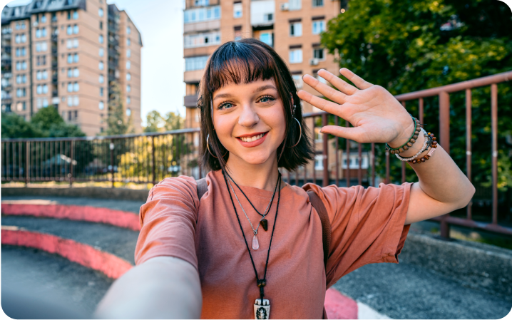 A women taking selfie on the background of tall building