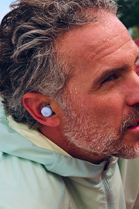 Image of a man wearing the Pixel Buds 2a in Iris colour