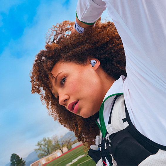 Picture of a woman in exercise gear wearing Pixel Buds 2a in Iris colour