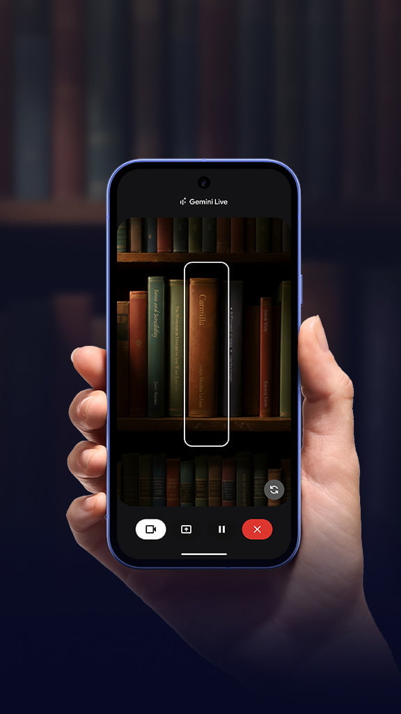 A hand holding a Pixel device in book shop environment, with rows of books on screen.