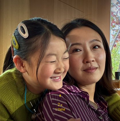 2x Telephoto feature in use, zooming in on mountain covered with trees and vegetation
